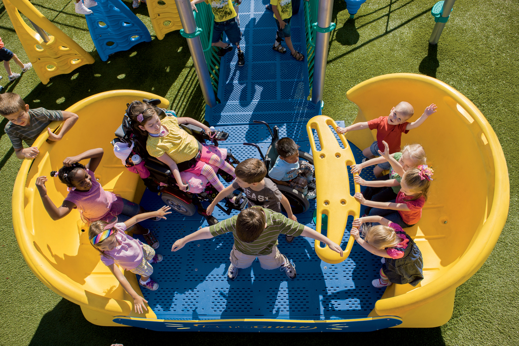 Group of children playing on an accessible playground structure