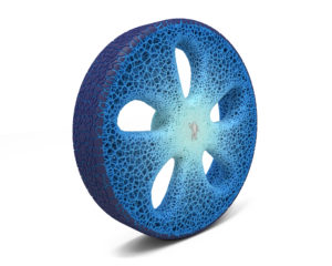 A blue tire made from a porous membrane with five petal-shaped cut outs around its center. The iconic Michelin man is at the very center.