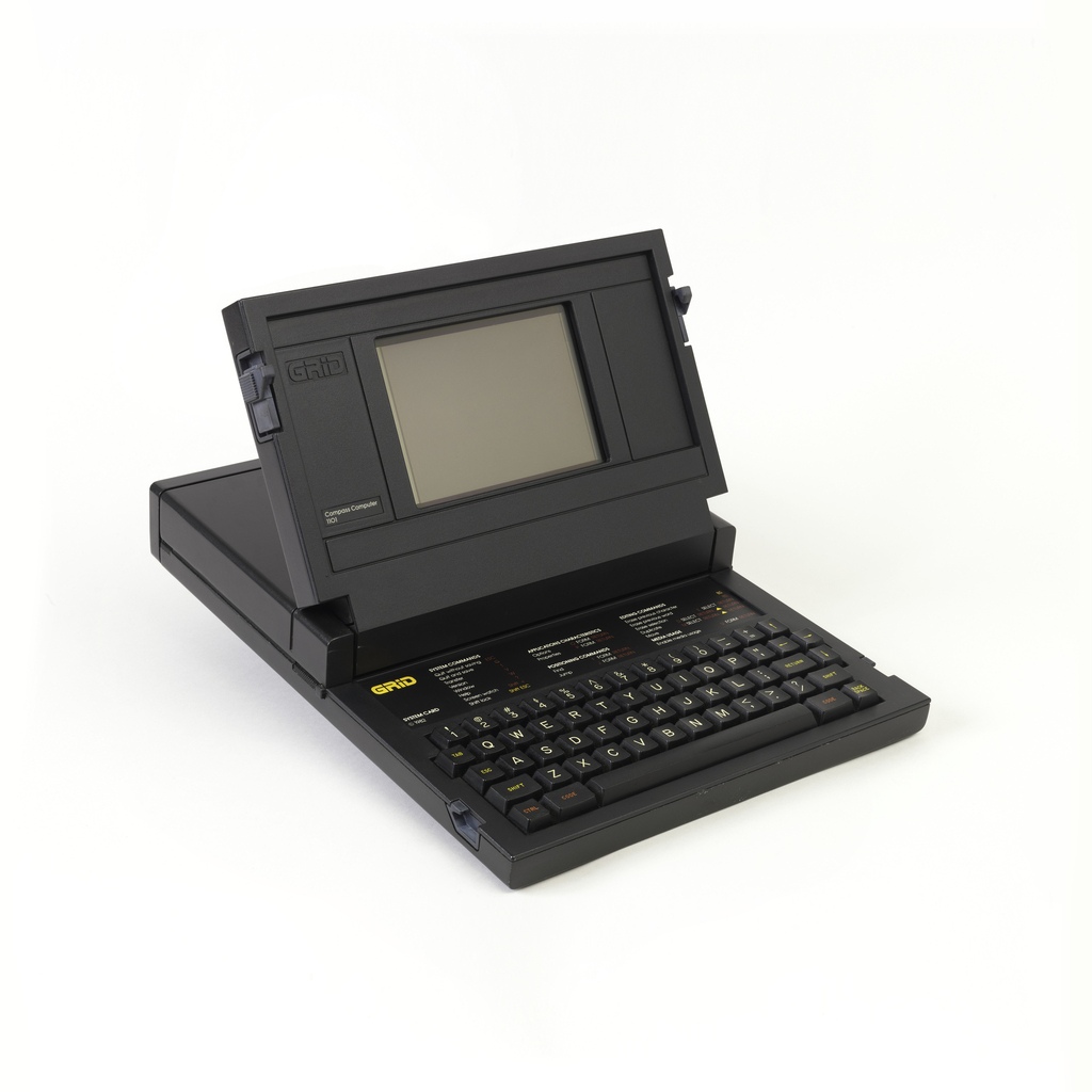 Image features laptop computer in a low, black rectangular housing, hinged at top center to open, clamshell-style, revealing a screen and keyboard. Please scroll down to read the blog post about this object.