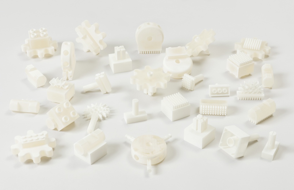 Image features white 3D-printed construction toy kit connectors of various shapes and sizes. Please scroll down to read the blog post about this object.