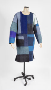 Image features: Long-sleeved, knee-length, reversible coat in needle-punched felt made from recycled sweaters. One side is a dark irregular plaid of blacks and blues, the other a patchwork of blue-tone knit fabrics. Please scroll down to read the blog post about this object.
