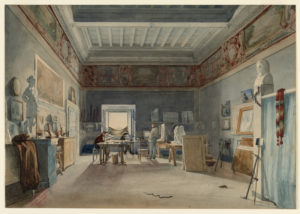 Image features three artists at work in a large studio space.
