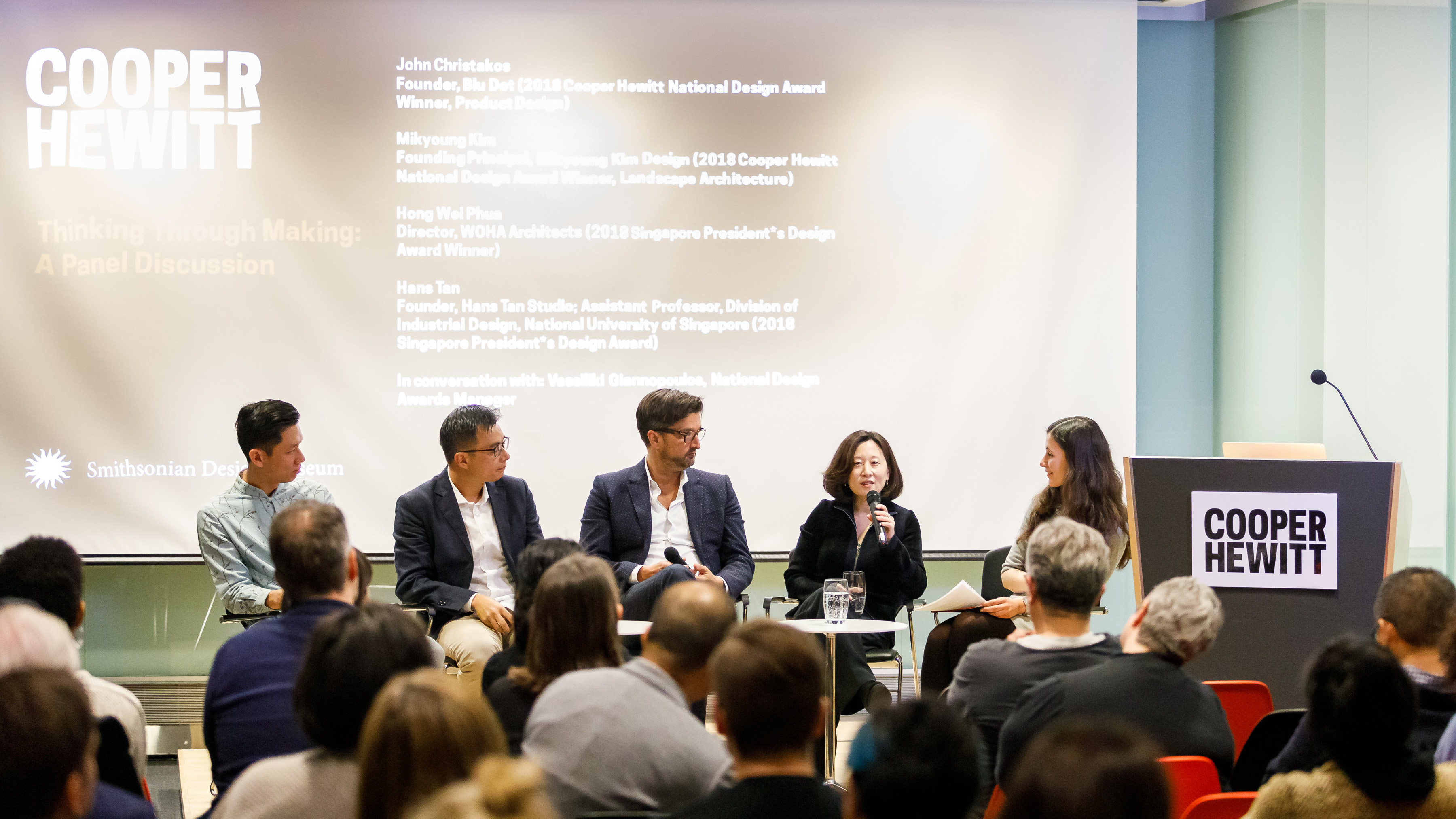 Image of a panel discussion at Cooper Hewitt. ON stage from left to right are Hans Tan, Hong Wei Phua, John Christakos, Mikyoung Kim, and Vasso Giannopoulos