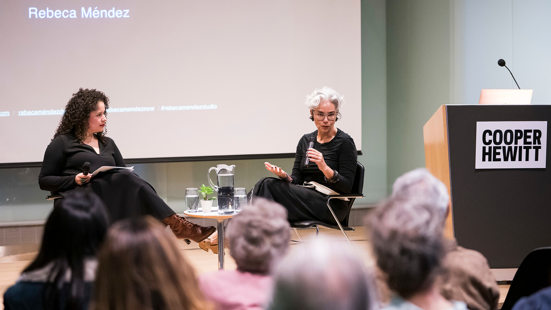 Image of Curator Christina de Leon and Rebeca Mendez, sitting on stage at Cooper Hewitt