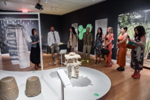Museum goers admire a stool made from crystallized salt as Andrea Lipps, a hip young curator with a brown bob haircut, explains the design.