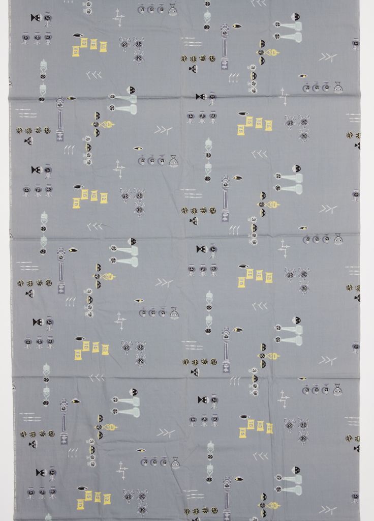 Image features: Length of printed cotton with a pattern of faces, clocks, and clock hands in black, white and yellow on a gray ground. Please scroll down to read the blog post about this object.