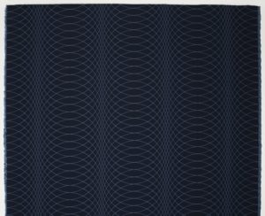 Image features a length of woven textile with a deep blue ground and pattern of curved intersecting lines in medium blue. Please scroll down to read the blog post about this object.