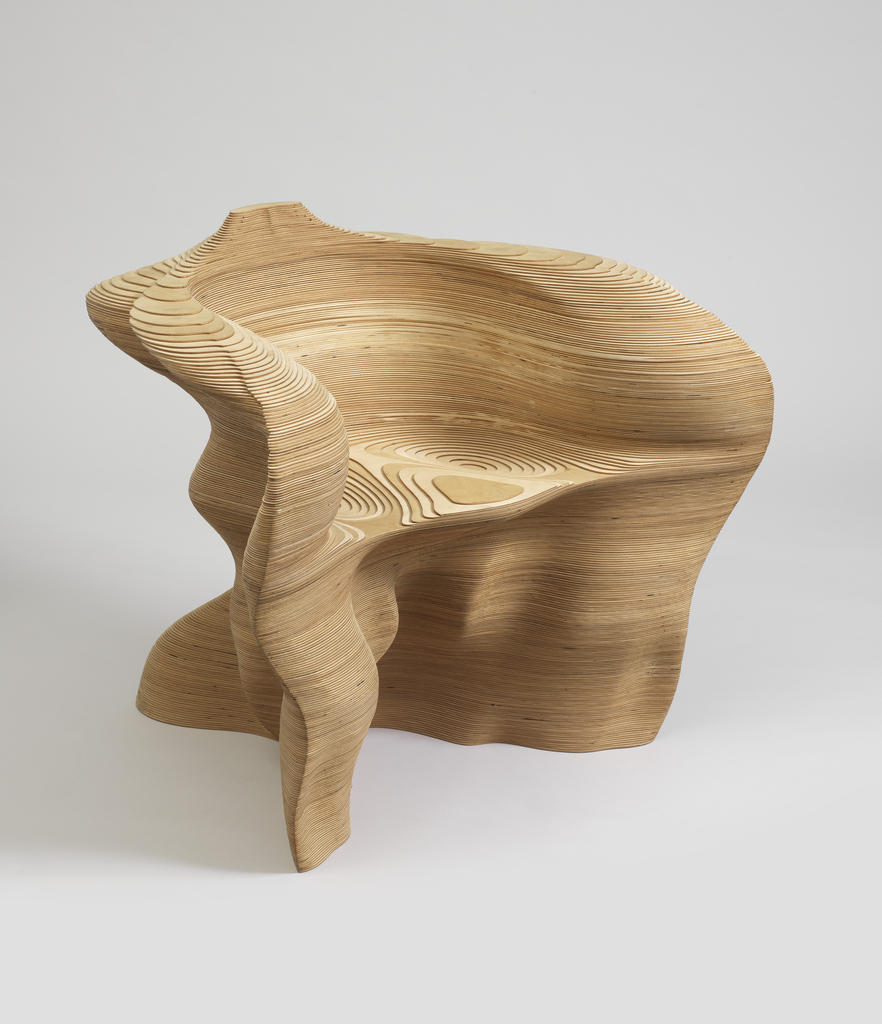 Image features an arm chair of irregular curved form composed of stacked thin contoured plywood sheets. Please scroll down to read the blog post about this object.