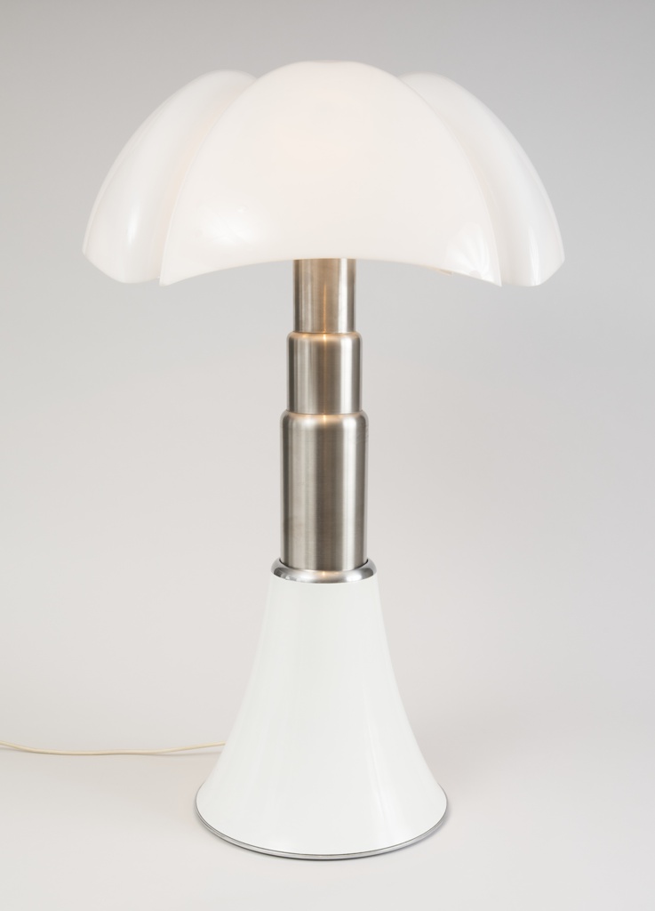 Image features a lamp composed of a curved, white translucent shade on a segmented stainless steel column with a white base. Please scroll down to read the blog post about this object.