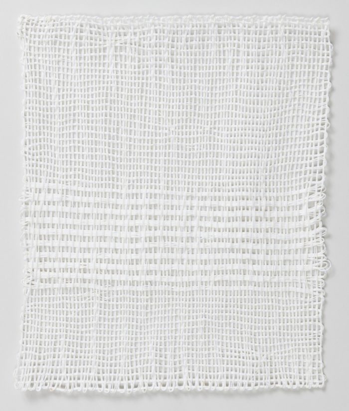 A white four-sided selvage textile loosely woven with striped pattern on the bottom half. Please scroll down to read the blog post about this object.