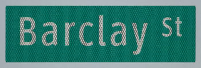 A green, New York City street sign composed of a landscape-orientation rectangle with 