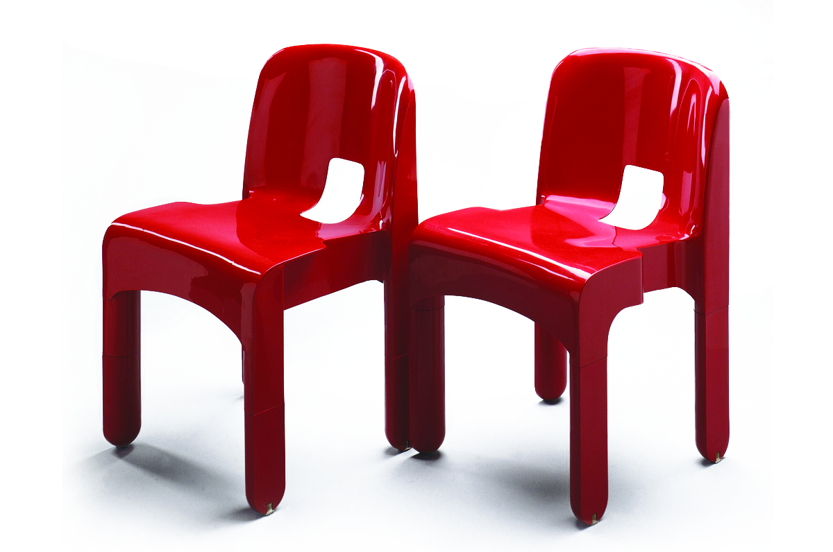 Two streamlined red chairs against a white background.