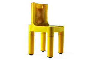 A yellow children's chair with a slatted back against a white background.
