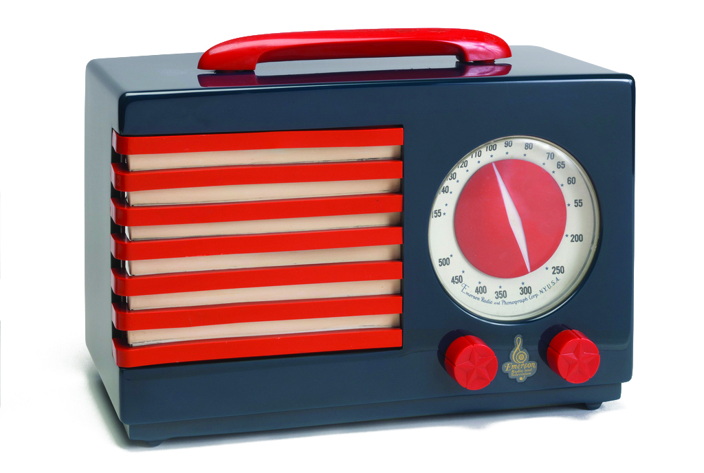 A rectangular radio sits against a white background. It is grayish blue with vibrant red details.