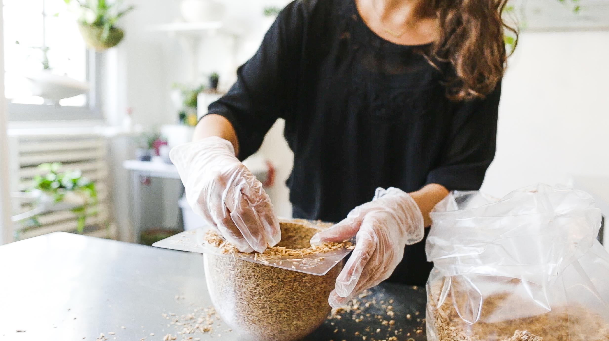 Drop In on Design | Biofabrication using Mushroom Mycelium. A woman wearing plastic gloves creates a bowl from a mold