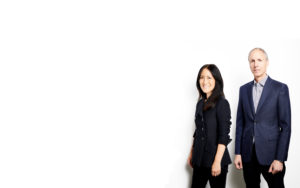 Craig, a tall white man with silver hair and a serious expression, and Lisa, an Asian-American woman who is smiling.