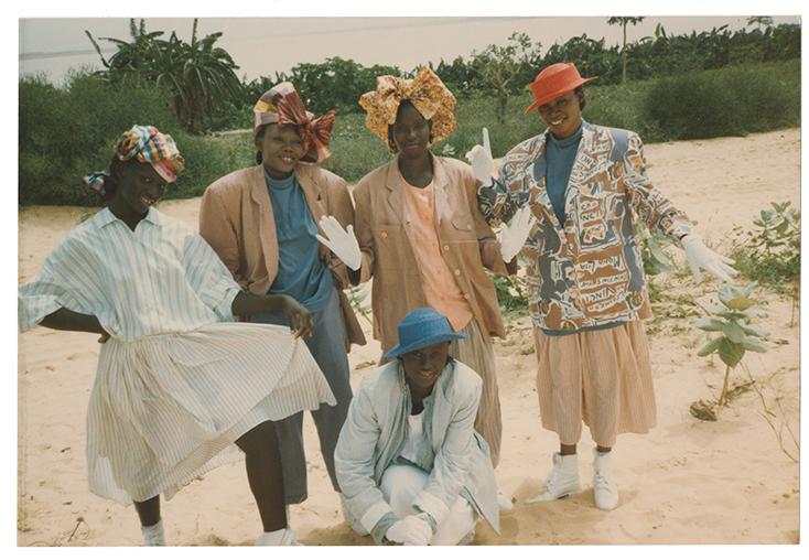 A group of women standing outside wearing Willi Smith designs and smiling for the camera