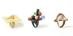 Three sculptual rings made by designer Karl Fritsch. Each ring is made with a different metal and features rough and sculptural elements, beset with colorful gems.