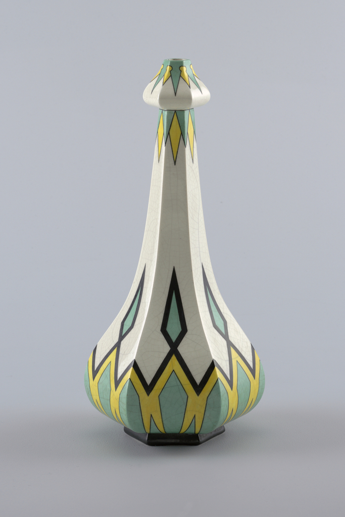 Image features a six-sided bottle-form vase with a bulbous bottom, ascending into a narrow neck, and a rounded arrow like top. The white body is decorated with a symmetrical pattern of diamonds in black, yellow, and mint green. Please scroll down to read the blog post about this object.