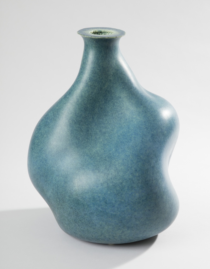 Image features a large, mottled-blue irregularly shaped plastic vessel tapering to a narrow neck with a circular mouth. Please scroll down to read the blog post about this object.