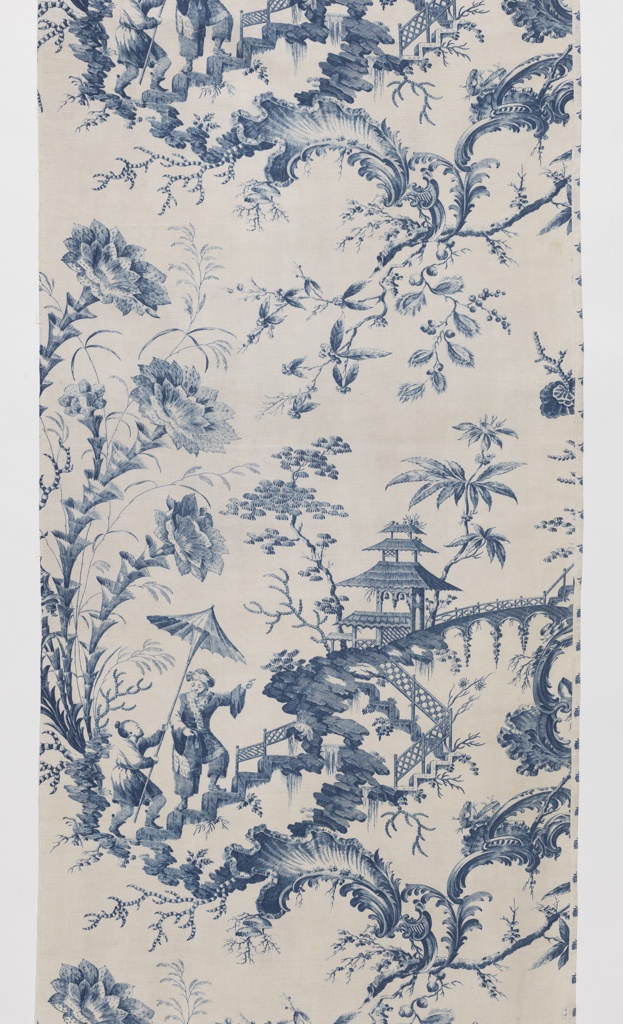 Image features a white curtain panel printed in blue with chinoiserie design. Two Asian-inspired figures climbing a fantasy stairway in mid-air, a figure pointing to the top of a hill where a pagoda-like structure sits. Oversized flowers, foliage, and rococo scrolls accent the landscape. Narrow rectangular panel with six tabs along top edge for hanging. Please scroll down to read the blog post about this object.