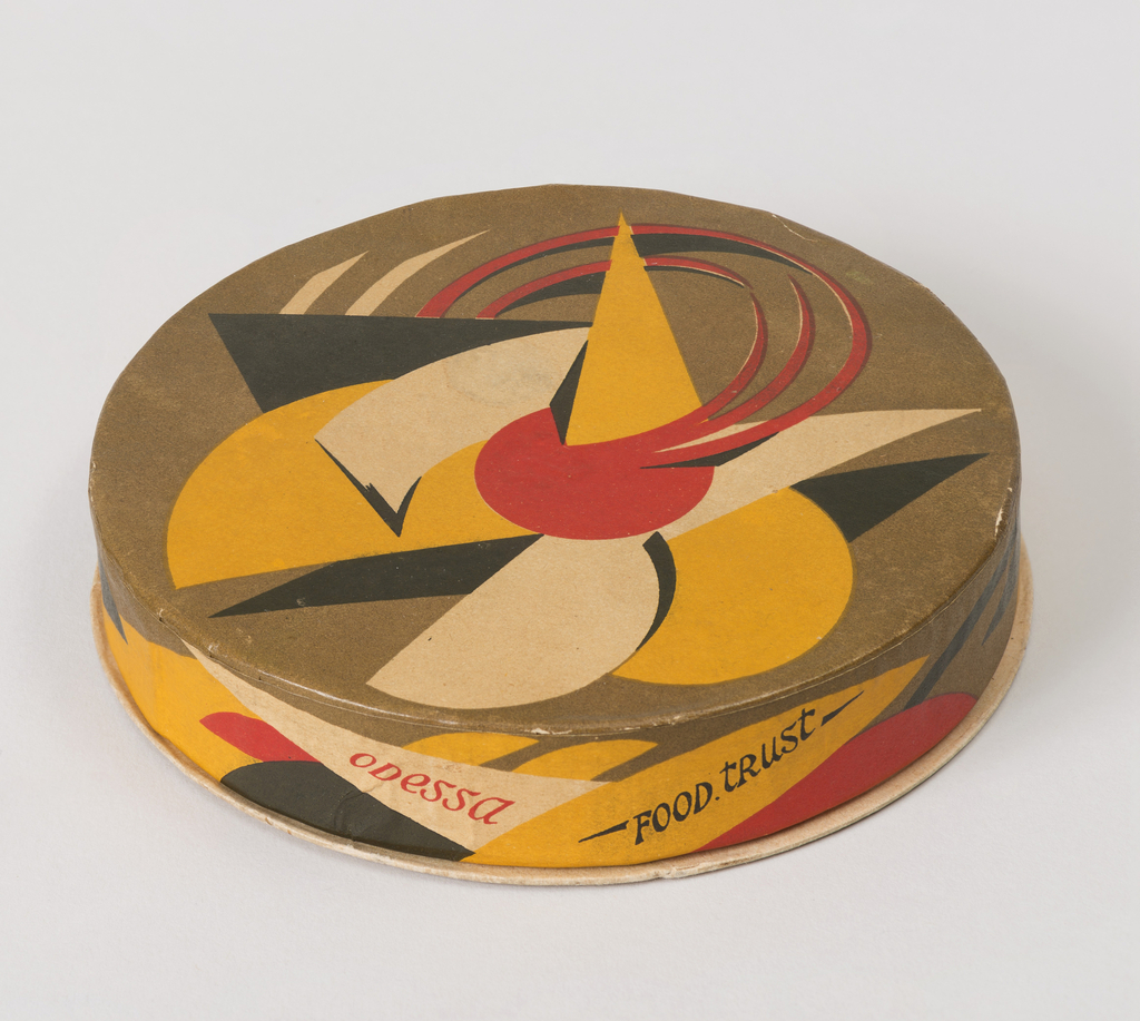 Image features a small circular box and lid with printed abstract geometric decoration in olive green, yellow, red and black; the words "ODESSA” (in red), “FOOD. TRUST (in black)" printed on the side of the lid, in English. Please scroll down to read the blog post about this object.