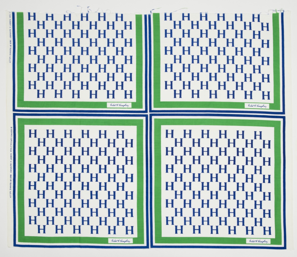 Image features a presidential campaign textile for Hubert H. Humphrey with alternating rows of the letter H enclosed by a green and blue border. Signature of Hubert H. Humphrey is in the bottom right of green border. Each square meant to be cut to make a campaign scarf. Please scroll down to read the blog post about this object.