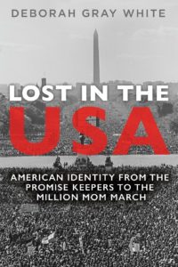 Book cover of Lost in the Usa: American Identity from the promise keepers to the million mom march by Deborah Gray White. It is illustrated with a black and white photo of thousands, perhaps tens of thousands, of people gathered in front of the Washington Monument in Washington, D.C.