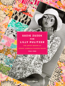 A book cover. Many colorful textiles designs are collaged around a black-and-white photograph of a woman, in sunglasses and a hat, blowing a kiss. Superimposed on that in the center is a pink rectangle with the book's title, "Suzie Zuzek for Lilly Pulitzer: The Artist Behind an Iconic American Fashion Brand, 1962–1985".
