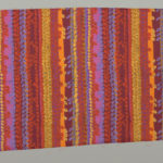 Image features: Printed length in a design of uneven vertical stripes with overlapping small oval leaf or bead shapes in strong reds, orange, blue, mauve and yellow. Please scroll down to read the blog post about this image.