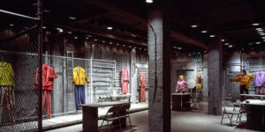 Industrial interior with colorful clothes hung on the walls