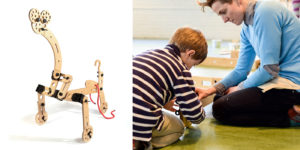 One half of the image shows a wooden toy shaped like a giraffe. The other half shows Cas Holman playing on the floor with a young child.