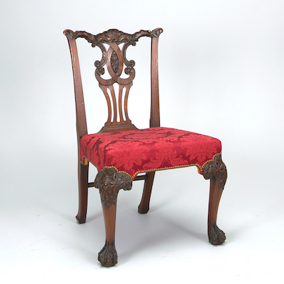 wooden chair with decorative back and red floral silk seat
