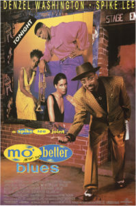 Poster for the Spike Lee film, ‘Mo' Better Blues.’ On the right, Spike Lee appears in front of a stage entrance, wearing a brown hat, glasses, brown pants, and brown houndstooth jacket. He looks at the viewer while bending and offering his right hand. His left hand holds a rolled up edition of the New York Post. Behind him, a brick wall is seen with a poster of three musicians and a trumpet, with the word TONIGHT in white against a black background in the upper left corner. Posters for Spike Lee’s film, ‘Do the Right Thing’ can be seen behind the musicians’ poster. Printed in yellow, upper margin: DENZEL WASHINGTON • SPIKE LEE; in yellow and blue, bottom left: a spike lee joint / mo’ better / blues. The words ‘spike’ and ‘better’ appear inside blue circles, while ‘lee’ and ‘mo’’ appear inside yellow circles. The film credits are listed in light grey at the bottom of the poster. The Spectral Recording/Dolby Studio logo appears on the bottom left, and the Universal logo appears on the bottom right.