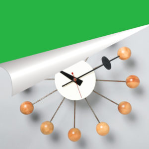 Photograph of a modern wall clock on a white wall, folded back to reveal a green background beneath.