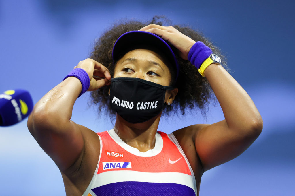 Tennis player Naomi Osaka wears a black face mask with the name 