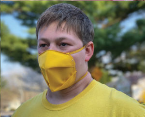 Light skinned person wearing bright yellow face mask