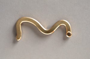 Squiggly bronze shape similar to a number 3 with a round opening at its right