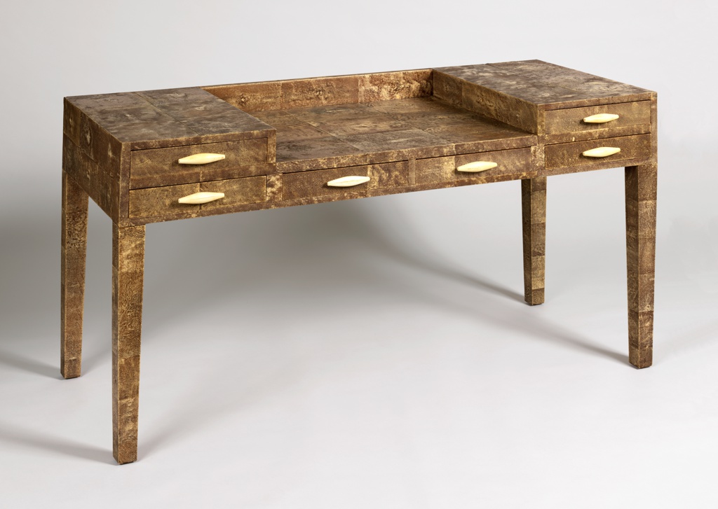 Brown-beige rectangular desk with six drawers and a center sunken section.