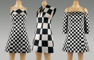 Three dresses with black and white checkerboard patterns displayed on mannequins.