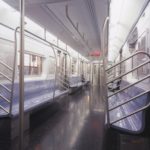 A photograph of the interior of an empty New York subway car.