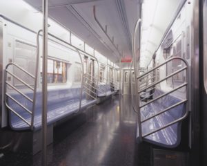A photograph of the interior of an empty New York subway car.