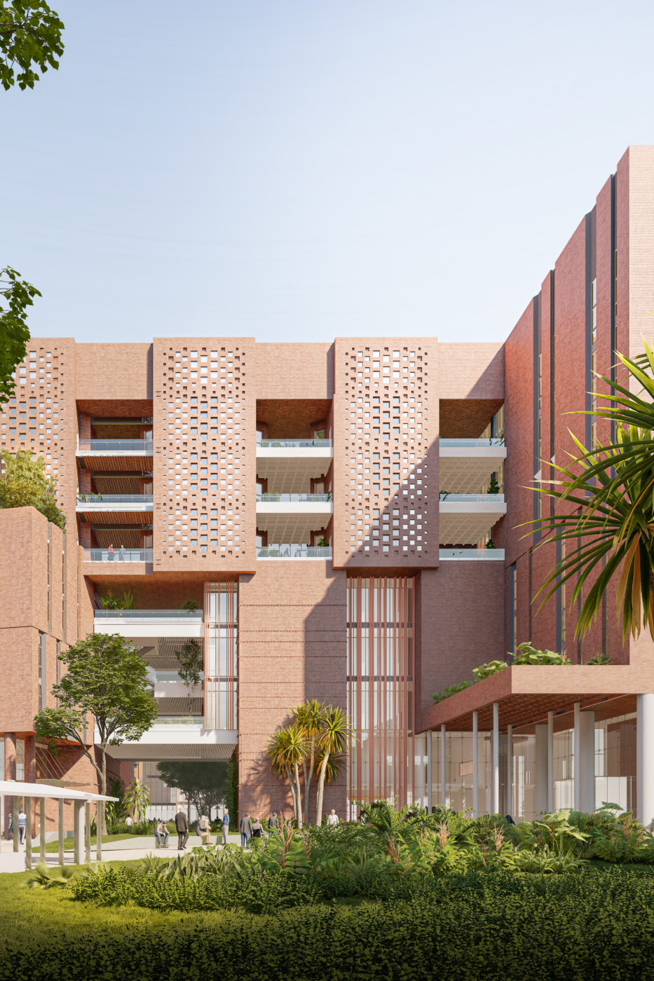 Exterior of a tall, sun-drenched brick building, surrounded by greenery, with several open-air terraces and a repeating pattern of small, square windows.