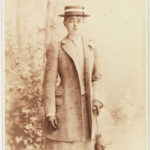 Young woman dressed in formal clothing looking directly at the viewer.