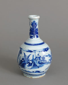 Gourd-shaped vase with chinoiserie figures rendered in shades of dark blue on pale blue background
