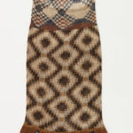 Long halter dress with intricate geometric checkered pattern in beige, shades of brown, and black