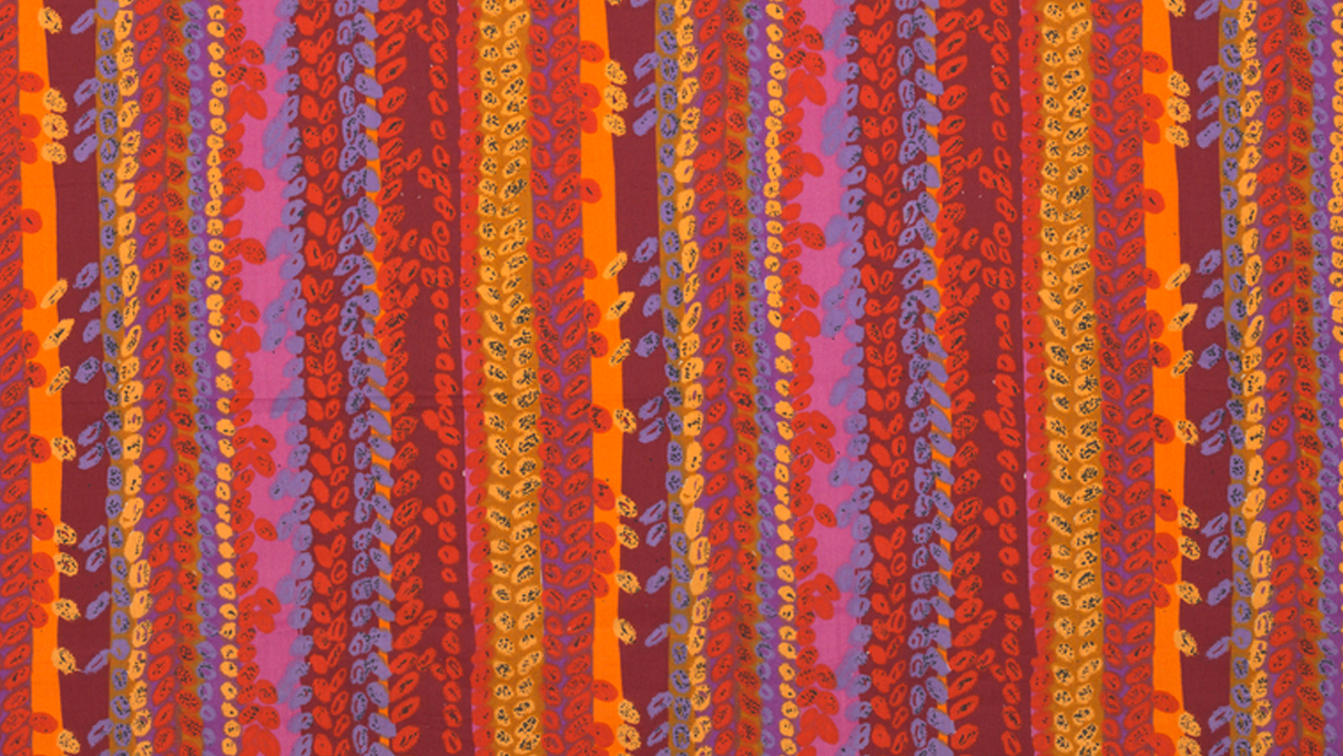 Vertical columns of vibrant reds, oranges, pinks, and purples cover a long, horizontal textile, with equally vibrant columns of leaf-like ovals overlaid on most of the fabric.