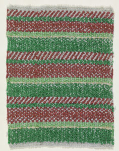 Textile made of cotton with alternating color patterns. Patterns visible are candy cane stripes, followed by solid green and red lines.