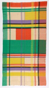 Brightly colored textile with a blocky plaid-like pattern in green, yellow, red, and purple.