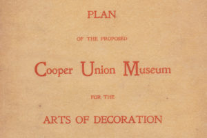 Detail of a book cover that reads in red lettering "Plan of the Proposed Cooper Union Museum for the Arts of Decoration" against a brown background.